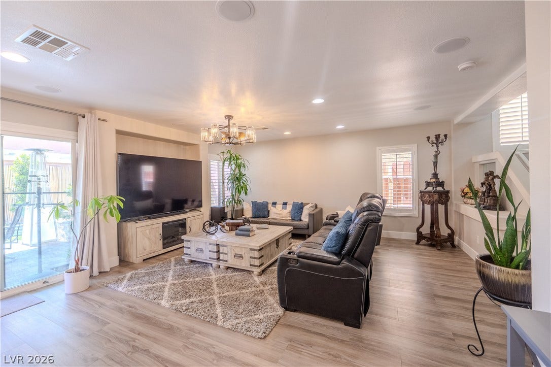 6007 Sonoma Station Avenue, Las Vegas, NV 89139 A spacious central gathering area features wood-look flooring and recessed overhead lighting.