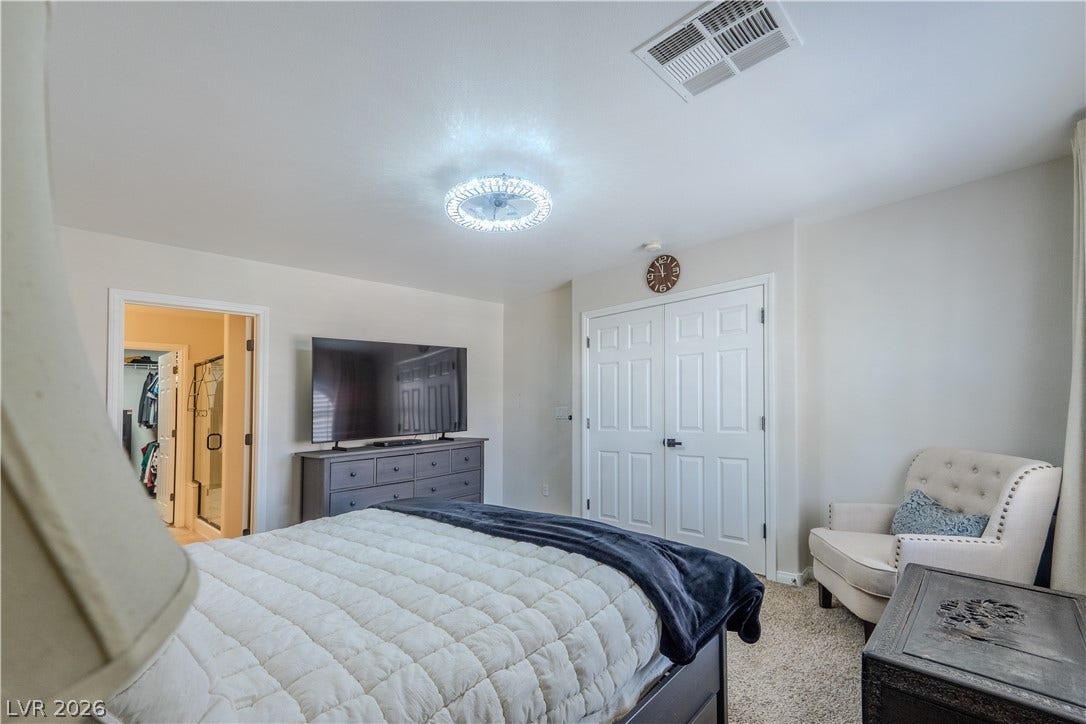 6007 Sonoma Station Avenue, Las Vegas, NV 89139 Plush carpeting anchors this comfortable bedroom suite featuring direct access to a private bathroom.
