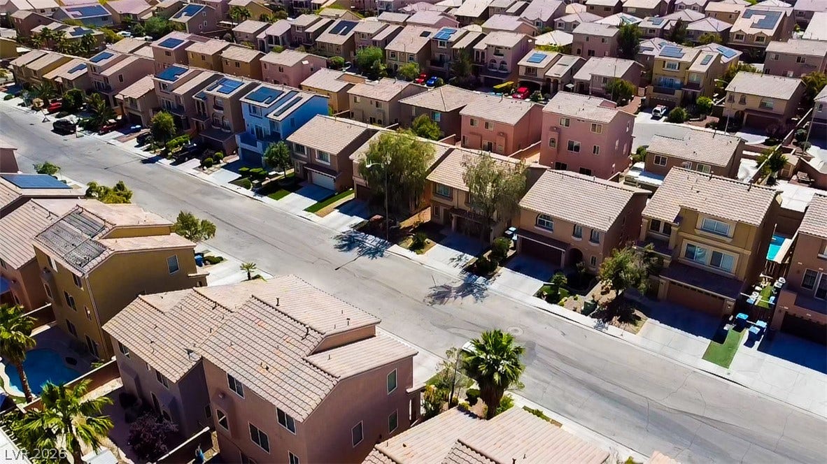 6007 Sonoma Station Avenue, Las Vegas, NV 89139 An aerial view showcases a peaceful suburban neighborhood lined with neatly arranged tile-roof homes.
