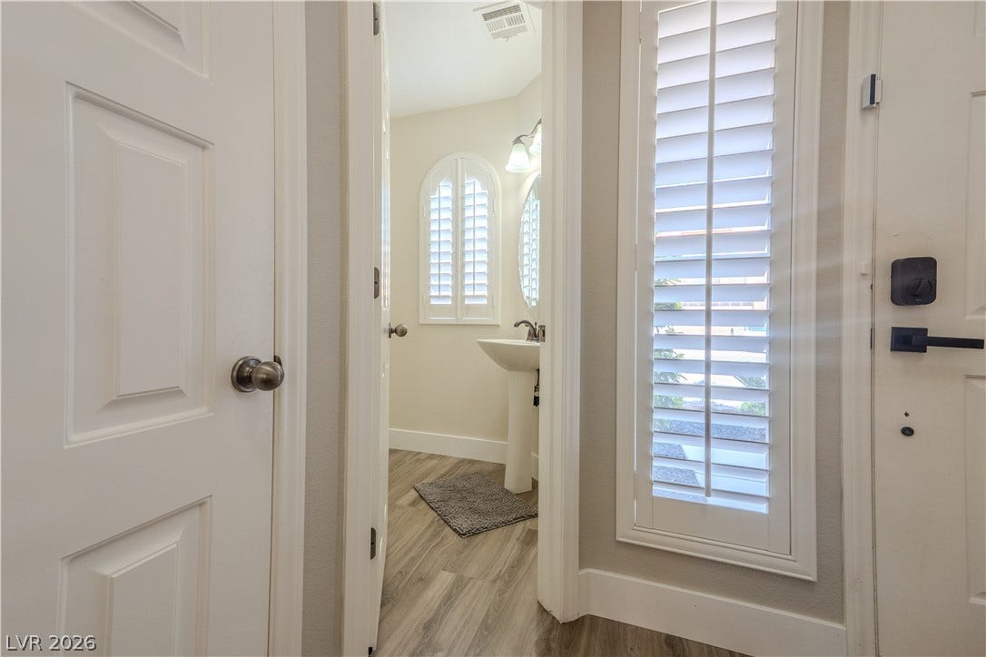 6007 Sonoma Station Avenue, Las Vegas, NV 89139 An inviting entryway leads directly to a convenient powder room featuring classic plantation shutters.