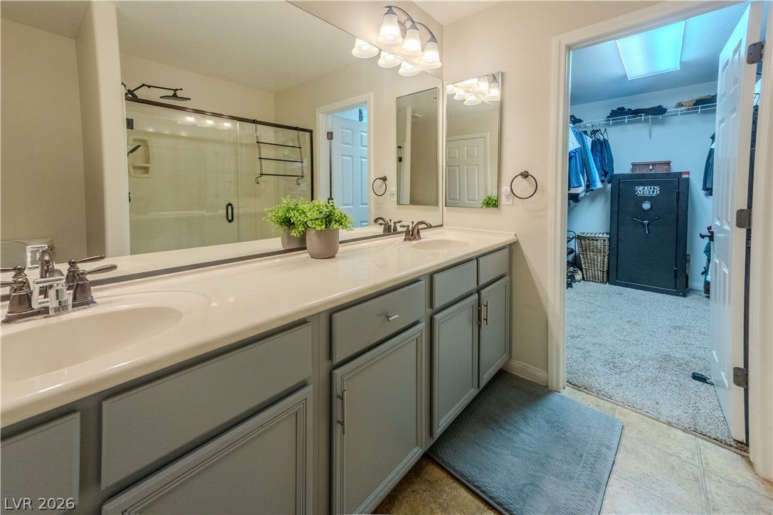 6007 Sonoma Station Avenue, Las Vegas, NV 89139 An expansive vanity counter transitions into a spacious walk-in closet.