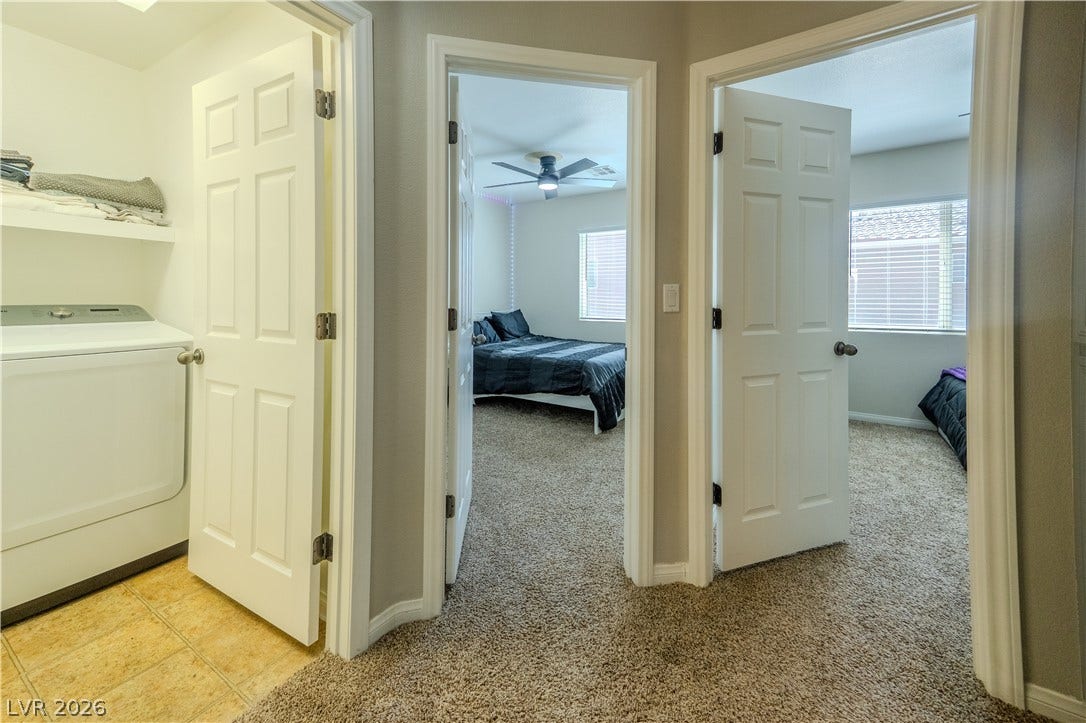 6007 Sonoma Station Avenue, Las Vegas, NV 89139 A central hallway connects plushly carpeted bedrooms to a convenient adjacent laundry closet.