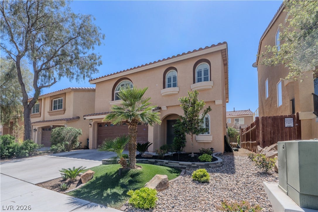 6007 Sonoma Station Avenue, Las Vegas, NV 89139 Mediterranean-inspired architectural details define this elegant two-story stucco exterior design.