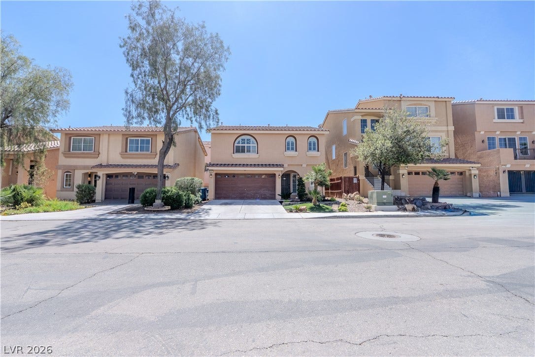 6007 Sonoma Station Avenue, Las Vegas, NV 89139 Stucco facades and tiled roofs highlight this quiet suburban streetscape.