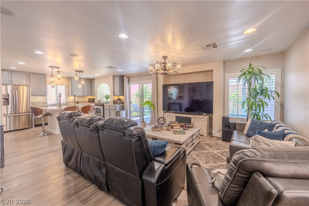 6007 Sonoma Station Avenue, Las Vegas, NV 89139 An open-concept living area flows seamlessly into the kitchen with wood-look flooring throughout.