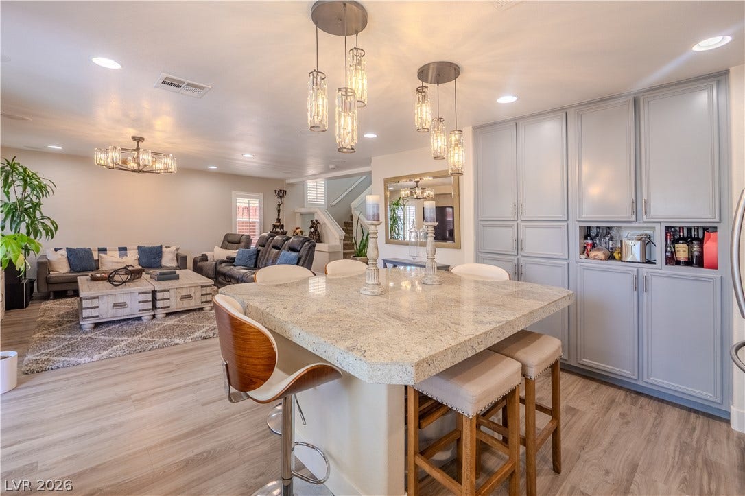 6007 Sonoma Station Avenue, Las Vegas, NV 89139 An open floorplan seamlessly connects the stone-countertop island to the adjacent living area.