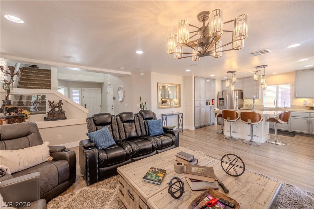 6007 Sonoma Station Avenue, Las Vegas, NV 89139 Gleaming hard surface floors flow throughout an airy, open-concept living area and modern kitchen.