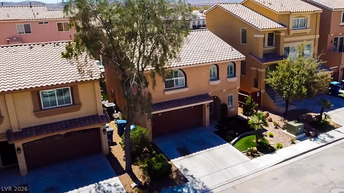6007 Sonoma Station Avenue, Las Vegas, NV 89139 Spanish tile roofing and an arched window design elevate this multi-level suburban home.
