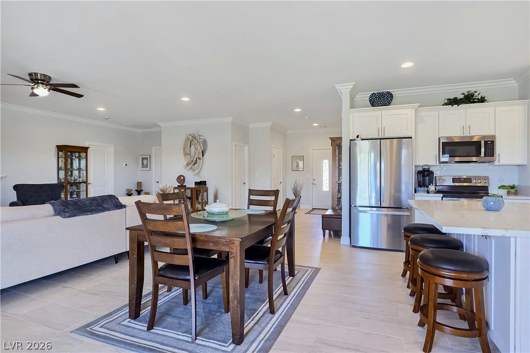 5471 Lincolnwood Court, Pahrump, NV 89061 Clean tile flooring and pristine crown molding accent this bright, open living space.