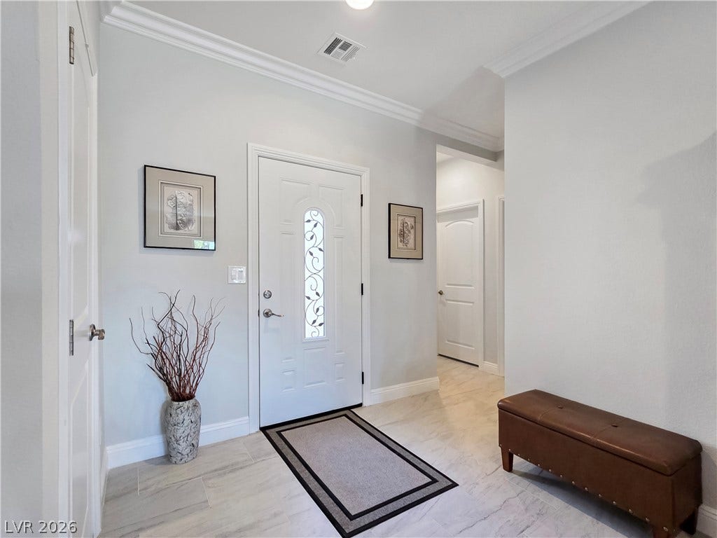5471 Lincolnwood Court, Pahrump, NV 89061 Crisp crown molding and tile floors define this inviting entryway.