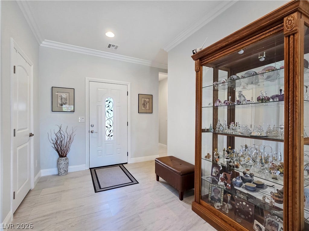 5471 Lincolnwood Court, Pahrump, NV 89061 Crown molding and tiled floors welcome guests into this elegant entryway.
