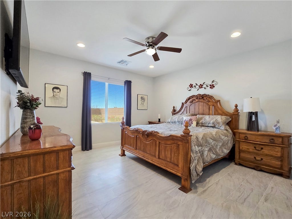 5471 Lincolnwood Court, Pahrump, NV 89061 A spacious bedroom featuring wood-look tile flooring and recessed lighting.
