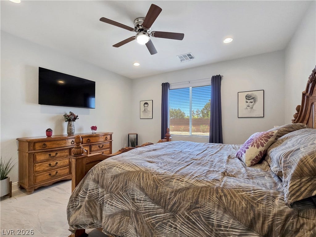 5471 Lincolnwood Court, Pahrump, NV 89061 Gleaming tile floors and recessed lighting enhance this airy bedroom retreat.