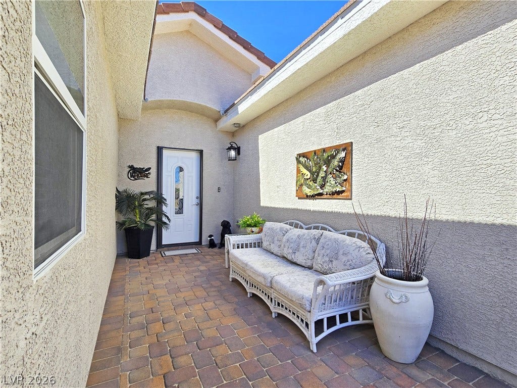 5471 Lincolnwood Court, Pahrump, NV 89061 Inviting brick paver courtyard leads directly to a private stucco entryway.