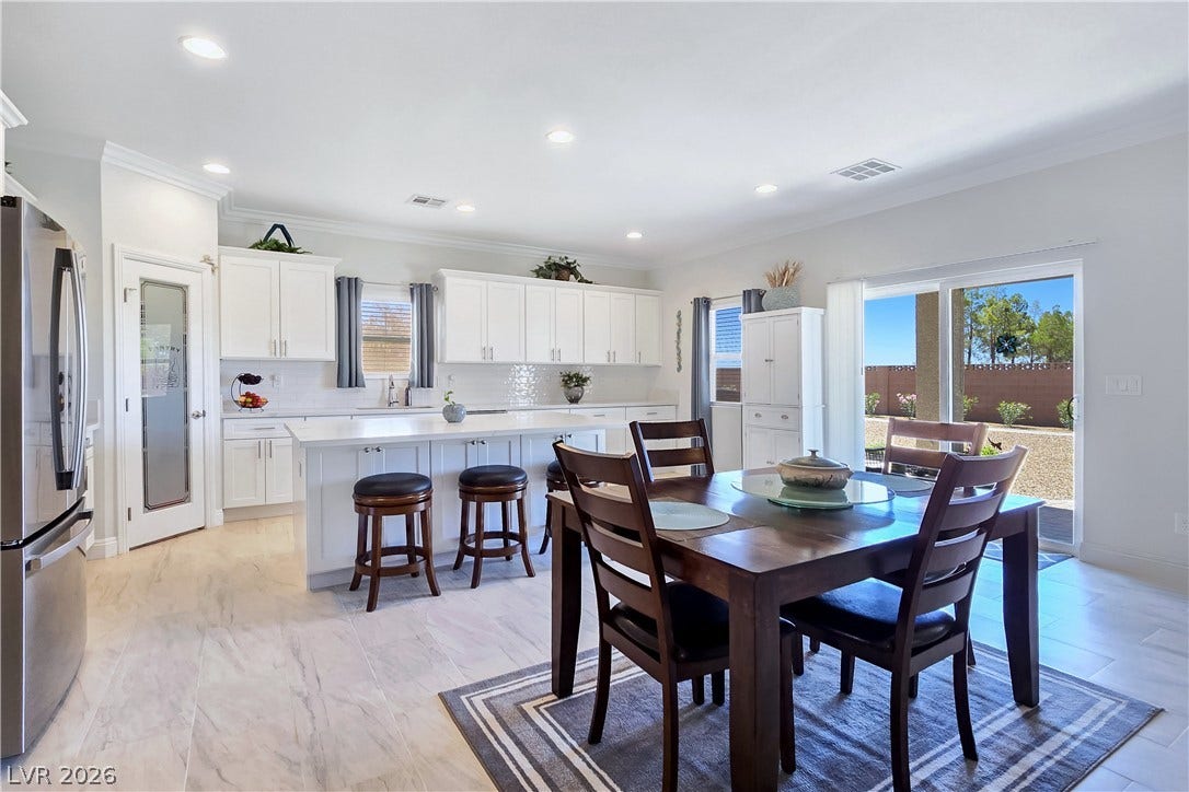 5471 Lincolnwood Court, Pahrump, NV 89061 Recessed lighting illuminates this tiled space, opening directly to the backyard via sliding glass doors.