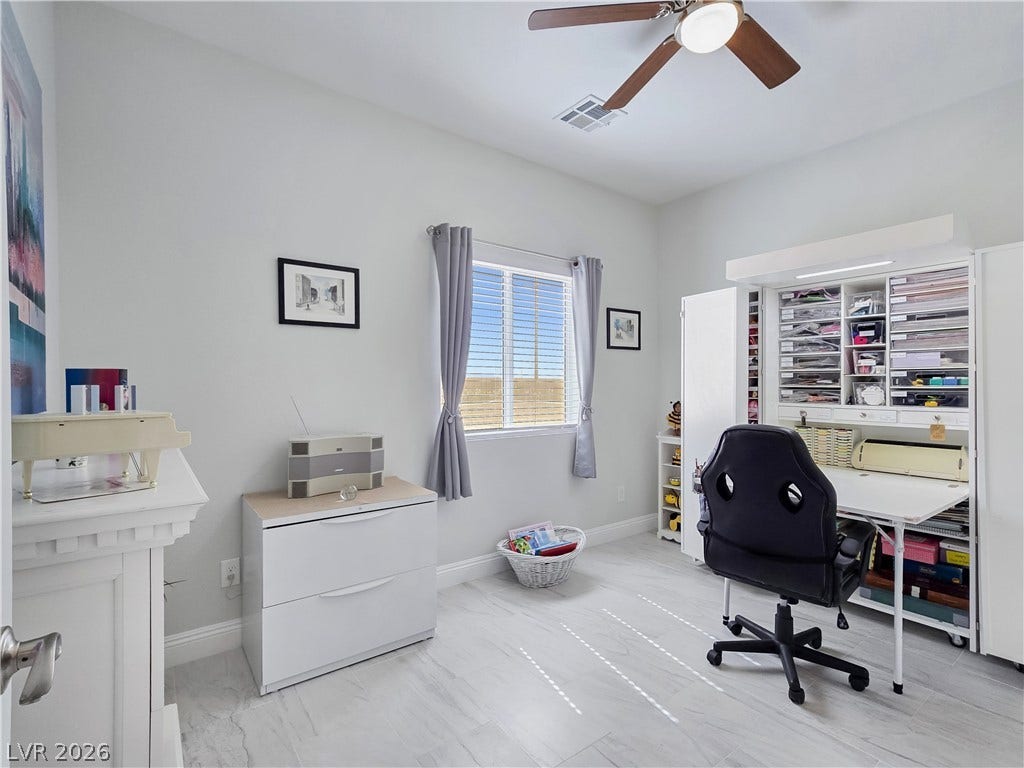 5471 Lincolnwood Court, Pahrump, NV 89061 Clean modern finishes and tiled flooring define this versatile home workspace.