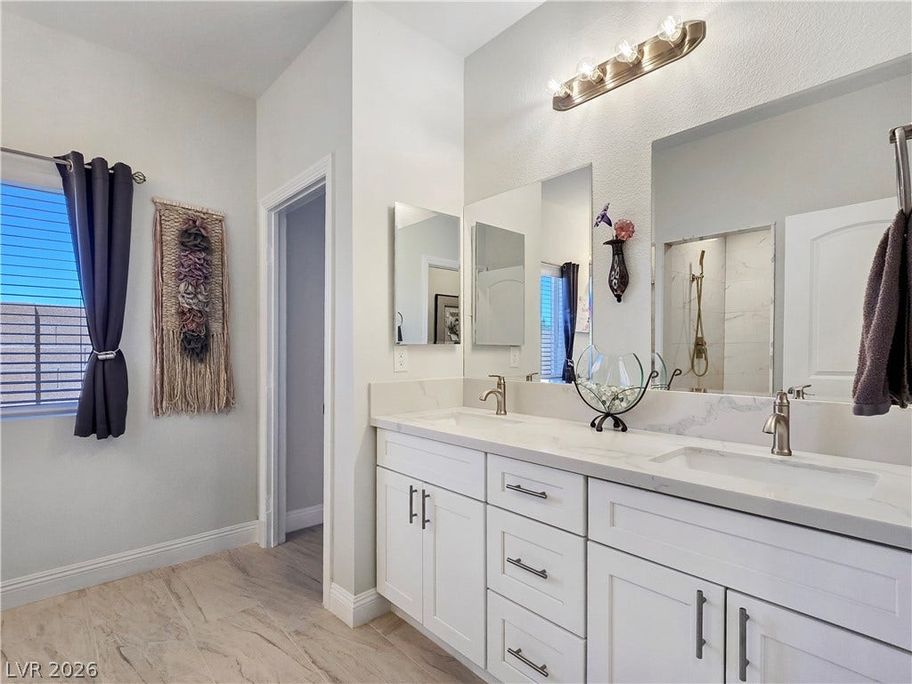 5471 Lincolnwood Court, Pahrump, NV 89061 Clean lines and a spacious dual vanity highlight this modern bathroom design.