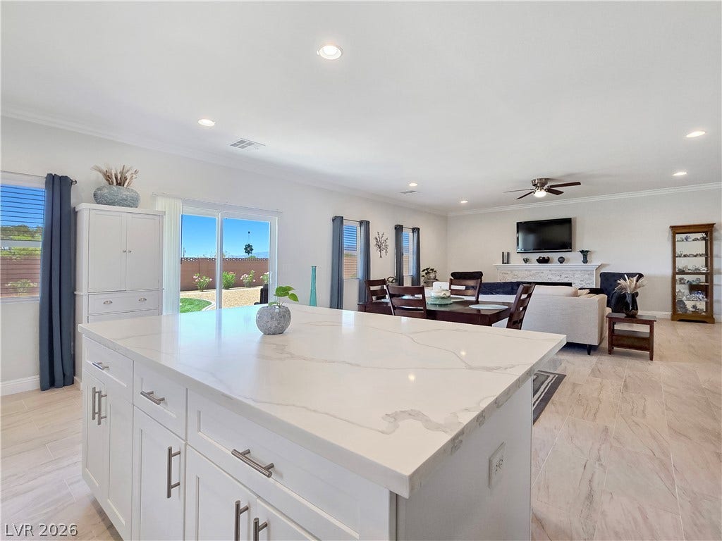 5471 Lincolnwood Court, Pahrump, NV 89061 An open floorplan seamlessly connects the stone-countertop island to the adjacent living area.