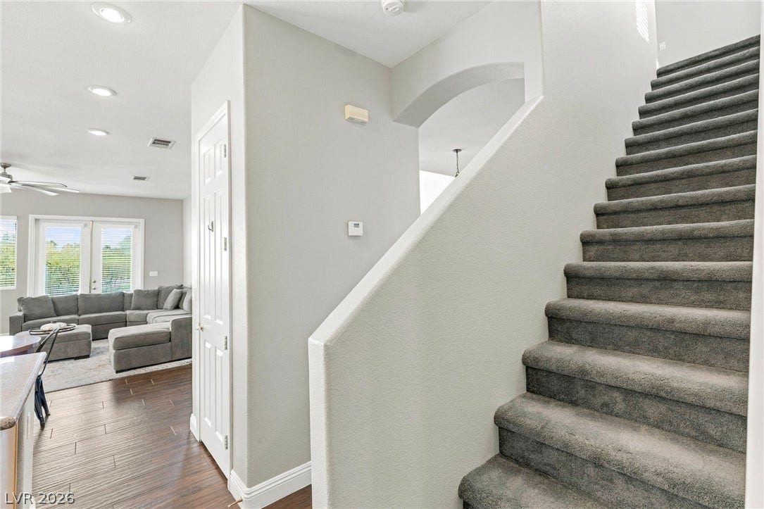 2984 Via Della Amore, Henderson, NV 89052 An inviting entrance with carpeted stairs connects seamlessly to the light-filled main living spaces.