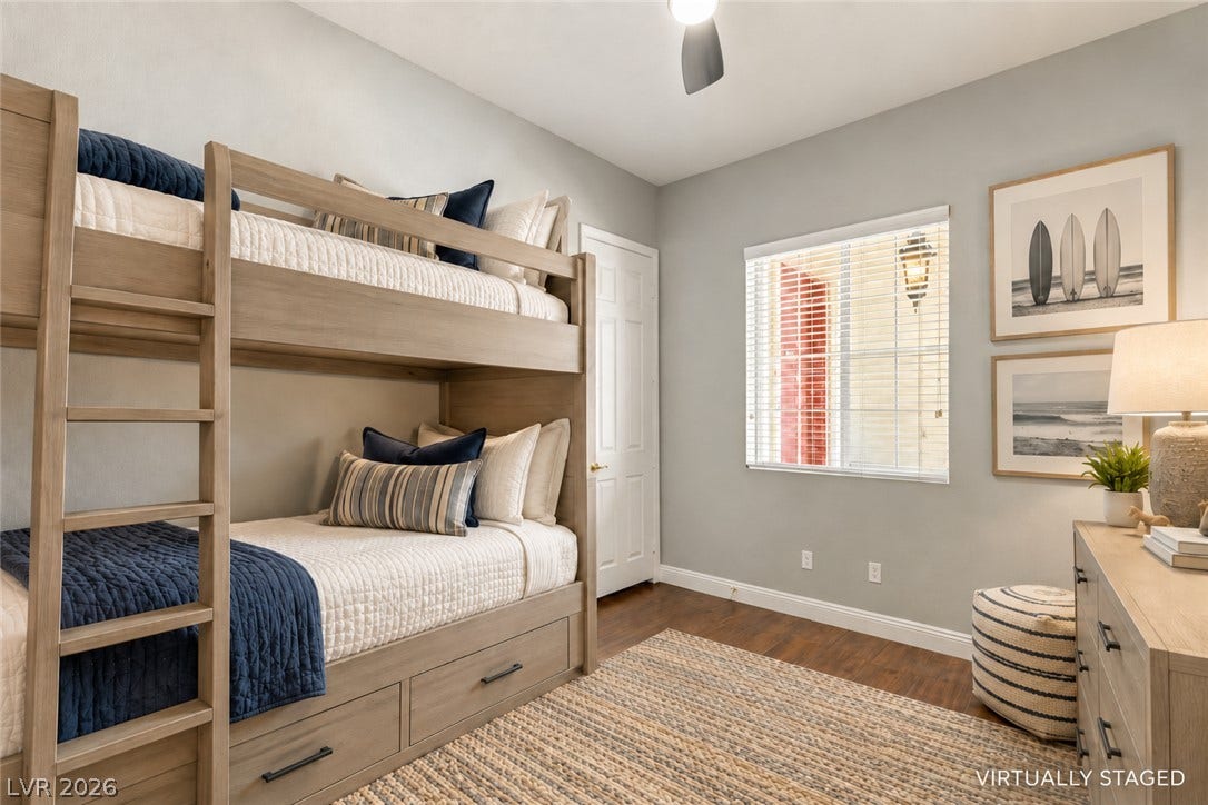 2984 Via Della Amore, Henderson, NV 89052 Rich hardwood flooring complements the neutral walls and classic window lines in this bedroom.