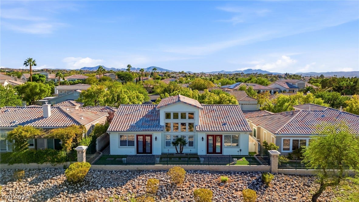 2984 Via Della Amore, Henderson, NV 89052 Distant mountains frame this classic tile-roof residence nestled within an established suburban neighborhood.