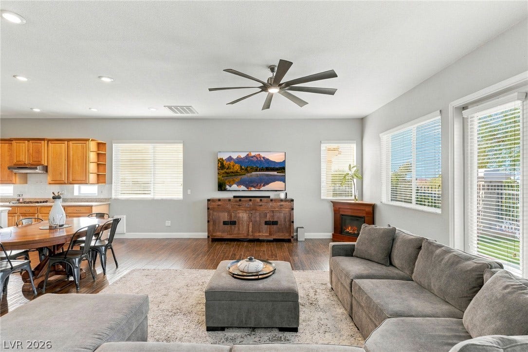 2984 Via Della Amore, Henderson, NV 89052 Hardwood floors and natural light from large windows define this open living space.