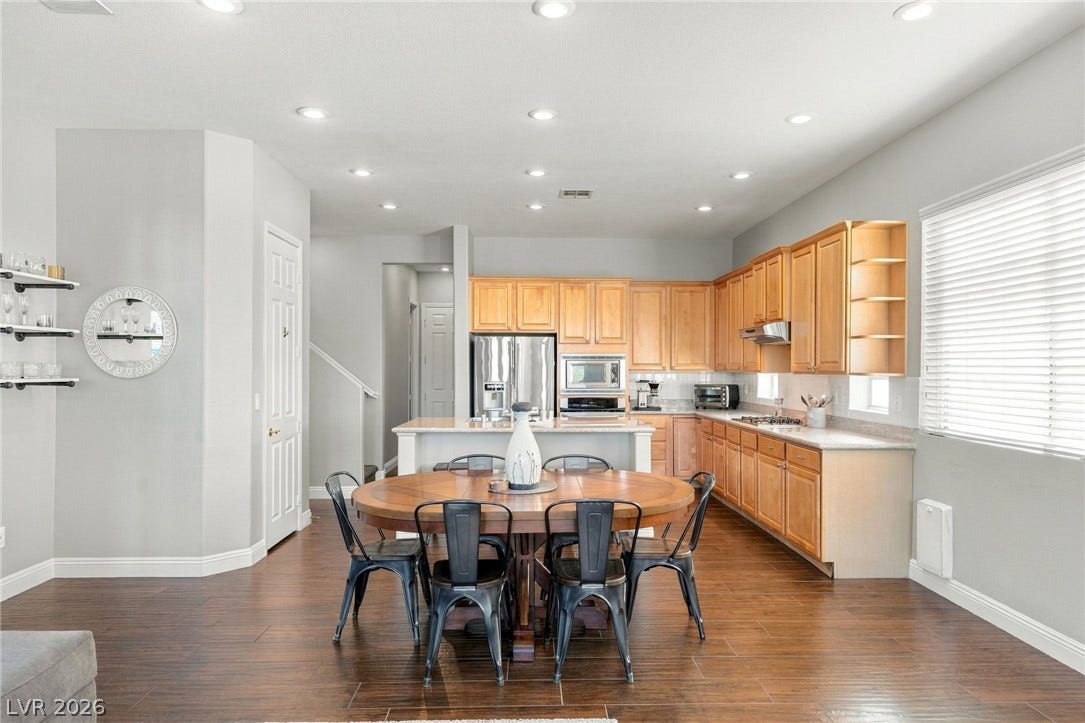 2984 Via Della Amore, Henderson, NV 89052 Gleaming hardwood floors and recessed lighting anchor this open-concept kitchen and dining area.