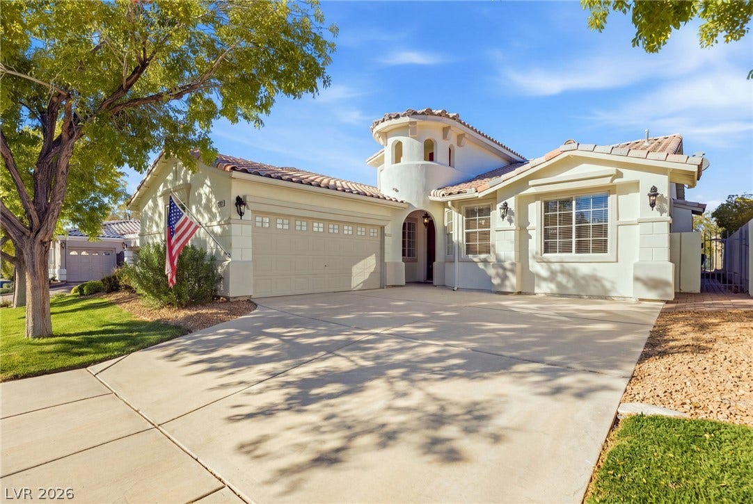 2984 Via Della Amore, Henderson, NV 89052 Spanish tile roof details and a curved entry turret highlight this classic stucco exterior.