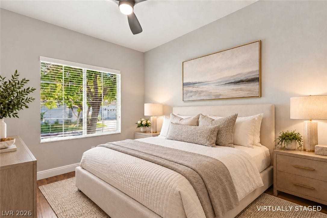 2984 Via Della Amore, Henderson, NV 89052 Rich wood floors and a wide window frame peaceful tree views in this inviting bedroom.