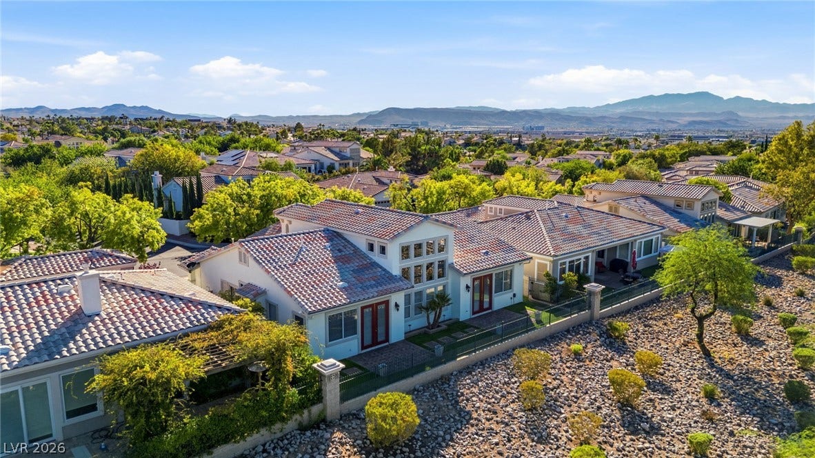 2984 Via Della Amore, Henderson, NV 89052 Distant mountains frame a collection of neighborhood homes topped with classic tile roofs.