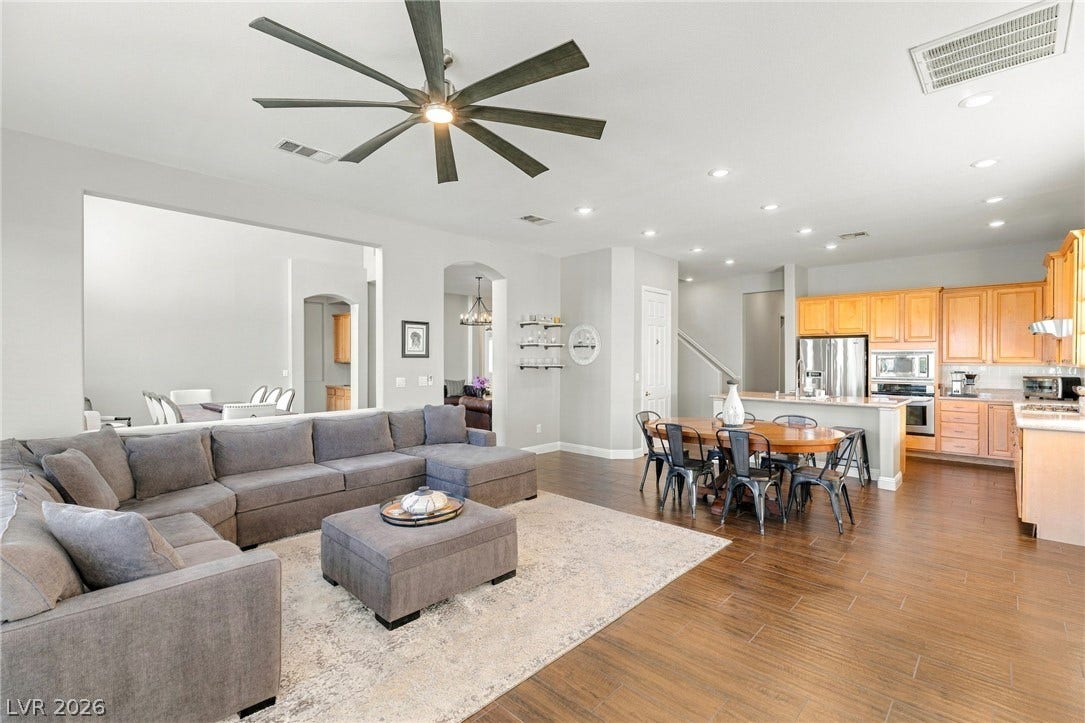 2984 Via Della Amore, Henderson, NV 89052 Gleaming wood-look floors unite the spacious main living areas in a seamless open-concept design.