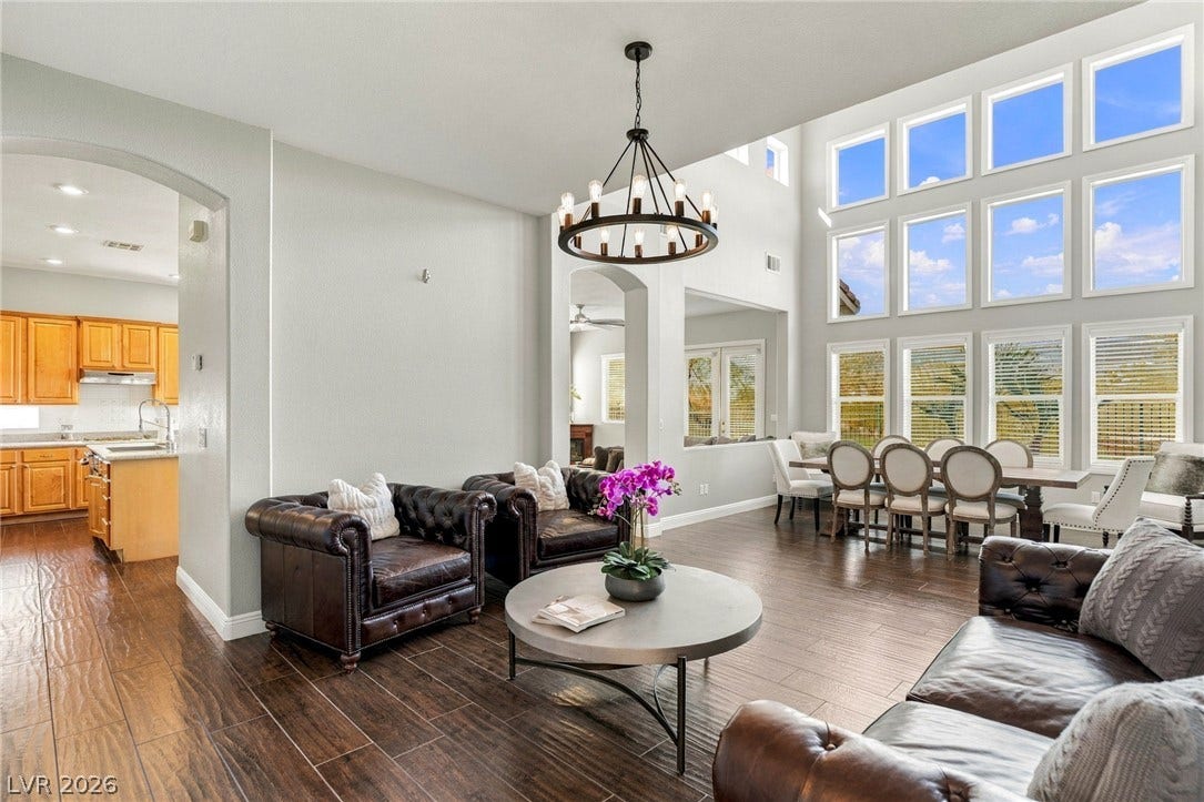 2984 Via Della Amore, Henderson, NV 89052 Towering windows illuminate the expansive open layout and rich wood-look flooring.