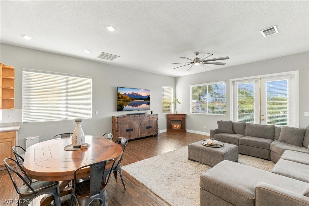 2984 Via Della Amore, Henderson, NV 89052 Gleaming hardwood floors and a fireplace enhance this open-concept main living space.