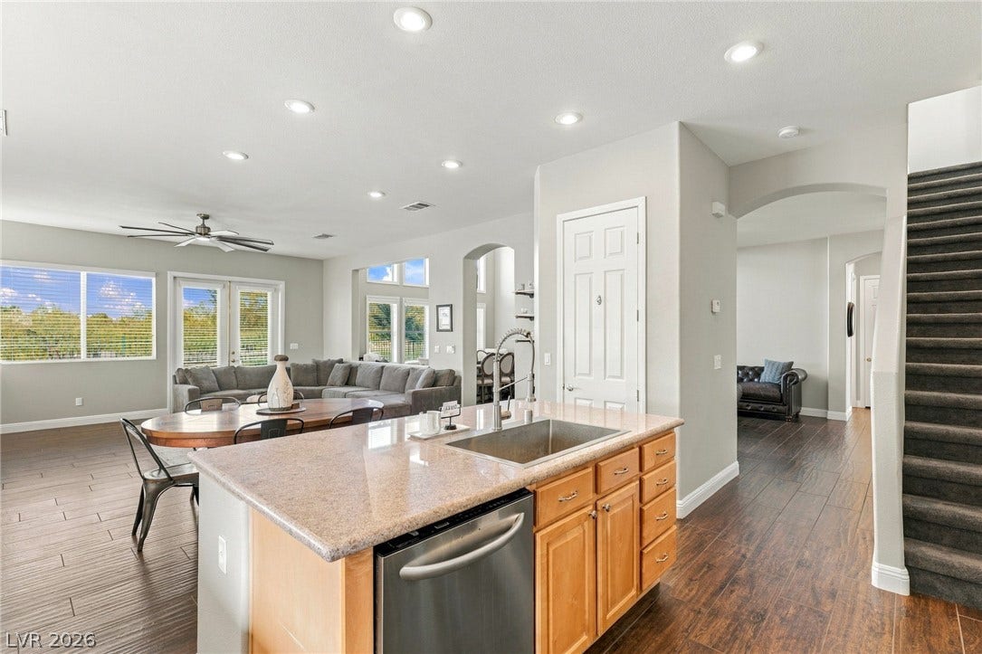 2984 Via Della Amore, Henderson, NV 89052 An open-concept layout connects the kitchen island to the dining and living spaces.