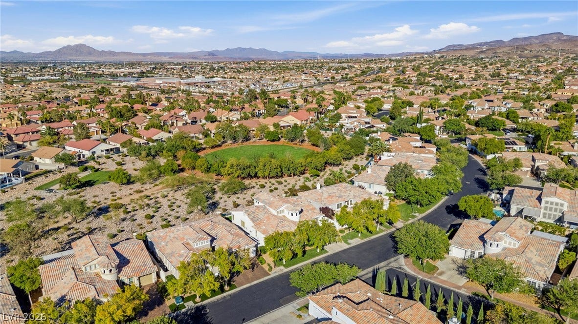 2984 Via Della Amore, Henderson, NV 89052 A sweeping panorama captures this desert community framed by mountain backdrops and manicured green space.