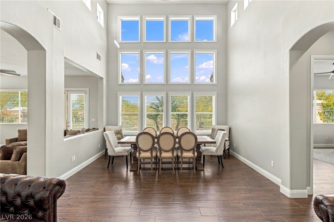 2984 Via Della Amore, Henderson, NV 89052 Soaring ceilings and an impressive wall of windows elevate this formal dining space.