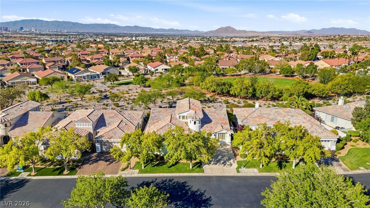 2984 Via Della Amore, Henderson, NV 89052 An aerial perspective captures tile-roofed residences nestled within an established desert community.
