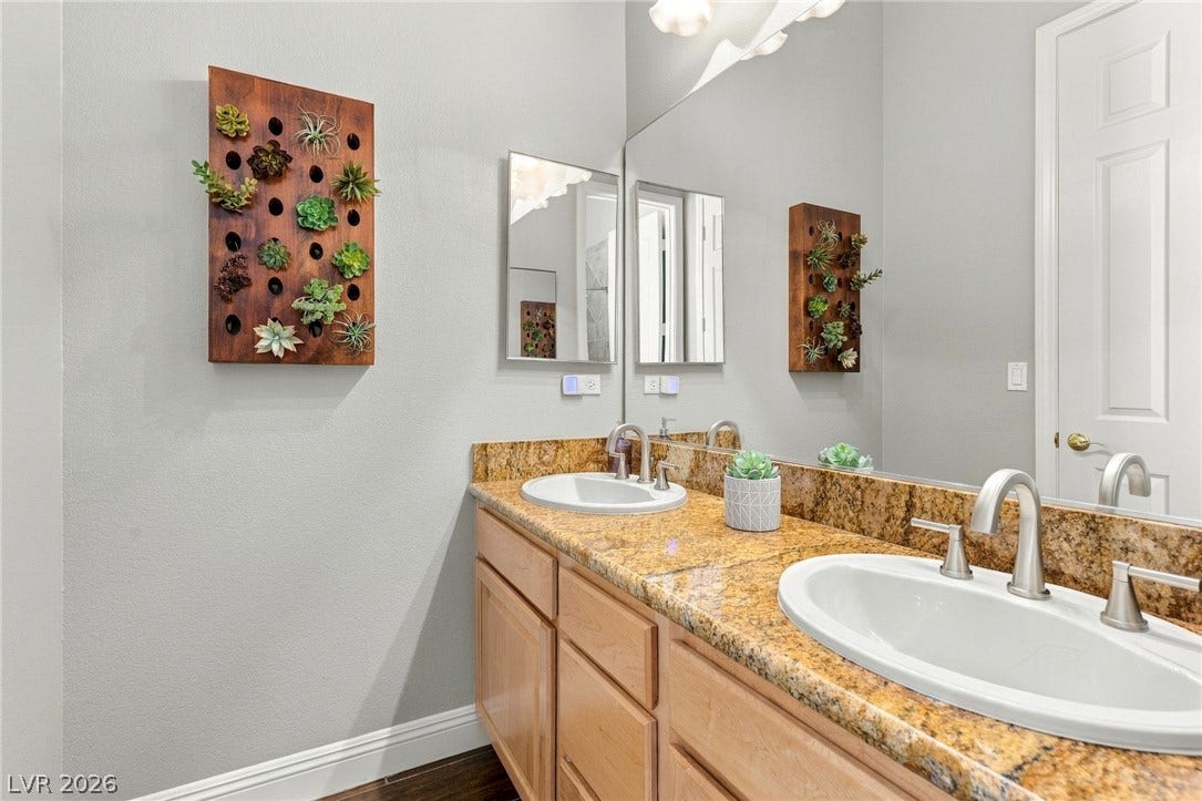 2984 Via Della Amore, Henderson, NV 89052 Granite countertops and double sinks elevate this well-appointed bathroom space.