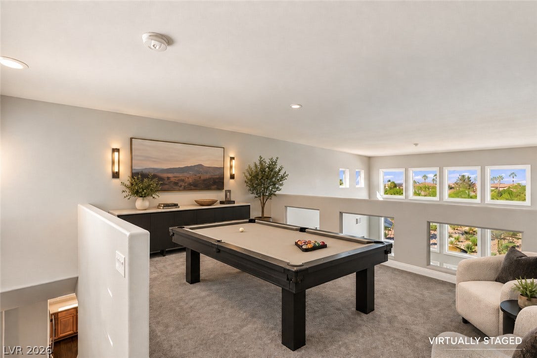 2984 Via Della Amore, Henderson, NV 89052 A spacious upper-level loft features wall-to-wall carpeting and elevated views through multiple clerestory windows.