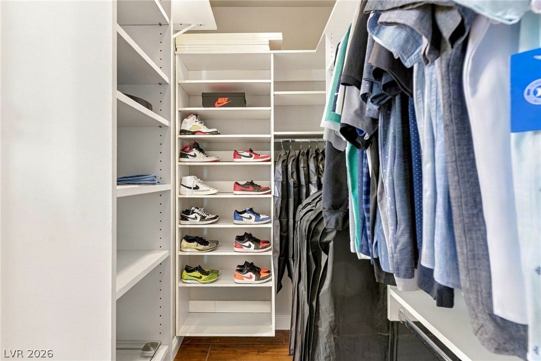 2984 Via Della Amore, Henderson, NV 89052 Custom built-in shelving and hanging rods maximize organization within this closet space.