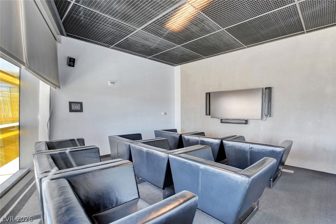 3722 Las Vegas Boulevard, #303, Las Vegas, NV 89158 Industrial style elements and a metal grid ceiling define this modern home theater room.