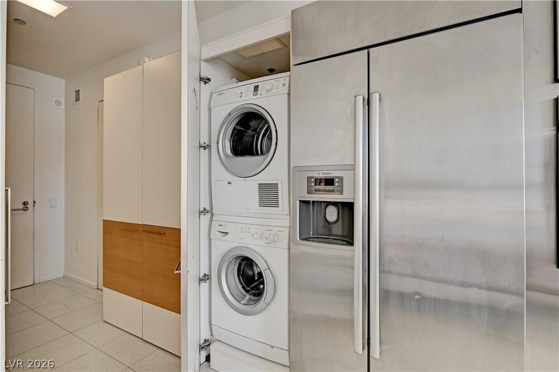3722 Las Vegas Boulevard, #303, Las Vegas, NV 89158 An in-unit stacked laundry setup sits adjacent to premium stainless steel appliances.