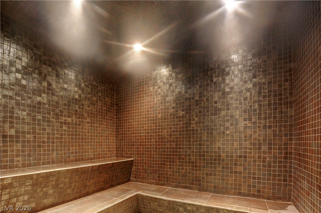 3722 Las Vegas Boulevard, #303, Las Vegas, NV 89158 Shimmering mosaic tile cladding and built-in bench seating create a private spa sanctuary.