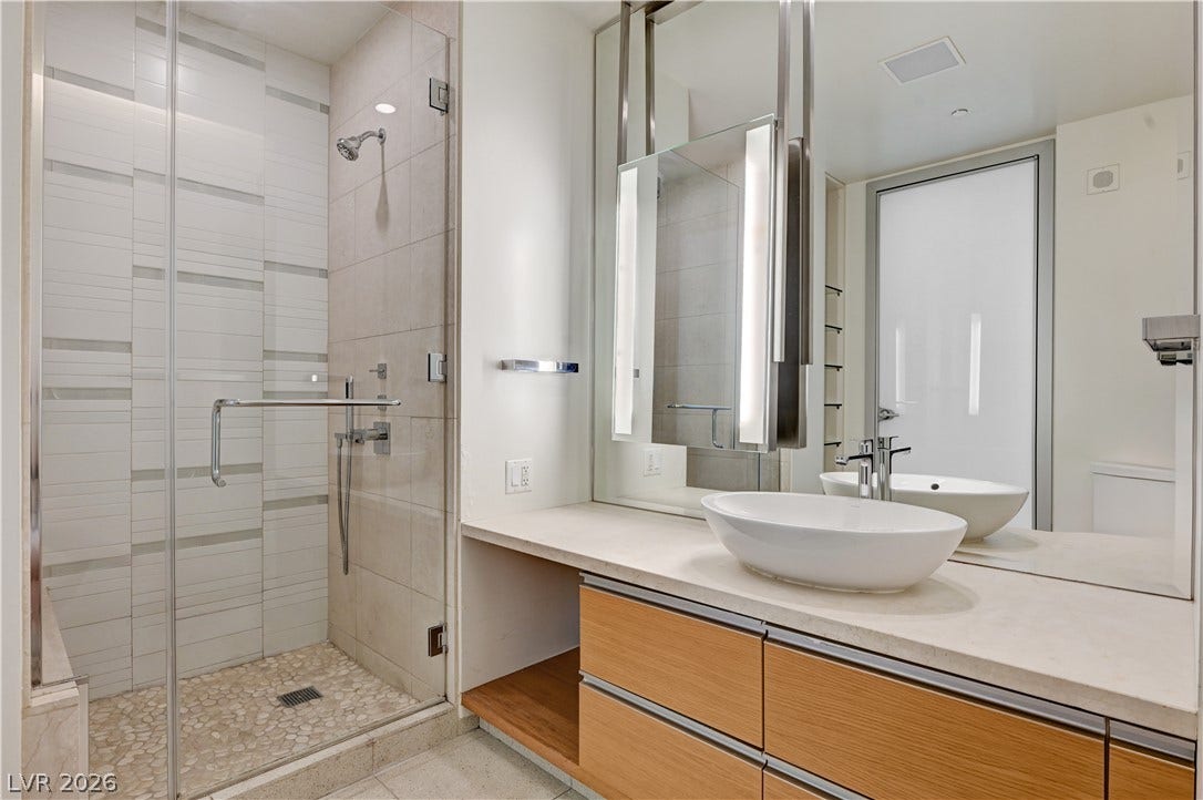 3722 Las Vegas Boulevard, #303, Las Vegas, NV 89158 A glass-enclosed shower highlights this modern washroom featuring a sleek floating vanity.