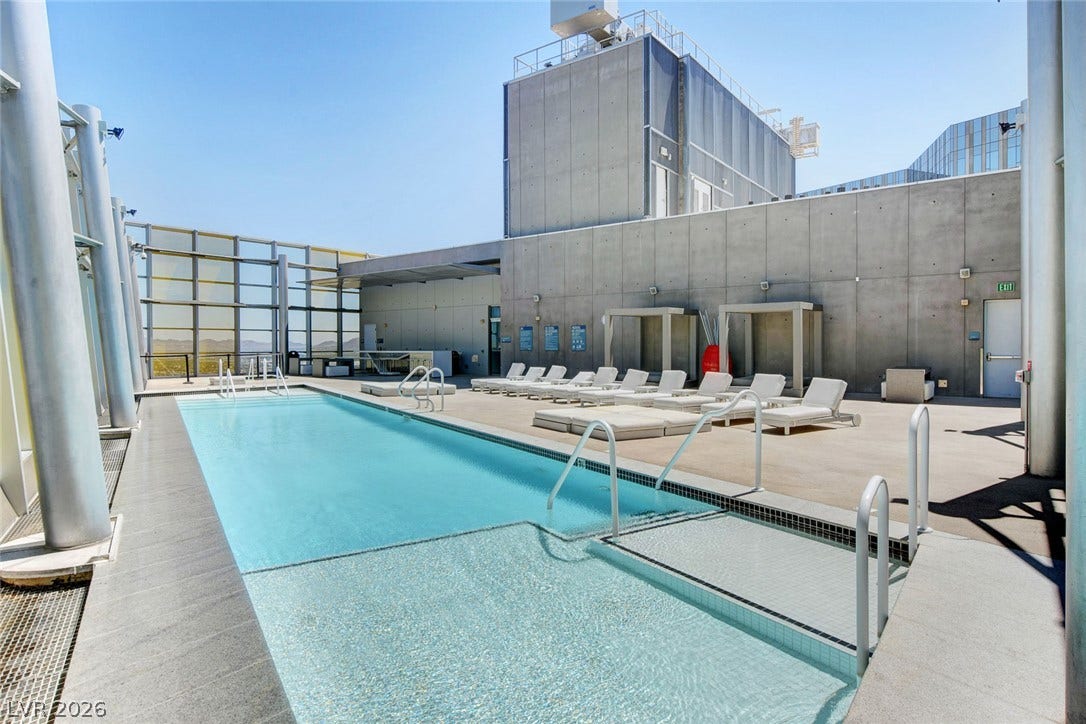 3722 Las Vegas Boulevard, #303, Las Vegas, NV 89158 A spacious rooftop swimming pool offers concrete decking and towering structural columns against the sky.
