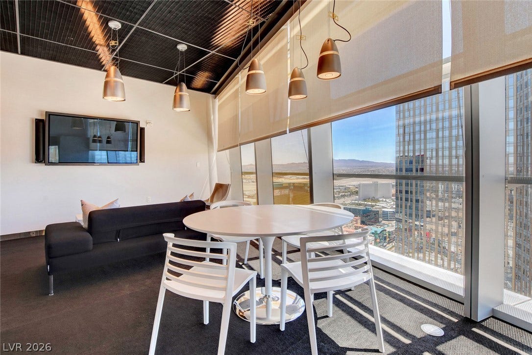 3722 Las Vegas Boulevard, #303, Las Vegas, NV 89158 Floor-to-ceiling windows frame impressive cityscape views from this modern high-rise living space.