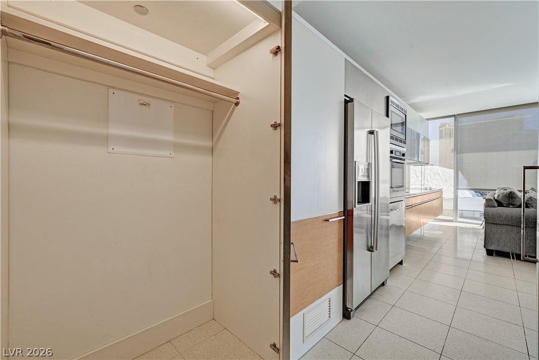 3722 Las Vegas Boulevard, #303, Las Vegas, NV 89158 Sleek tile flooring and integrated stainless steel appliances anchor this modern linear kitchen.