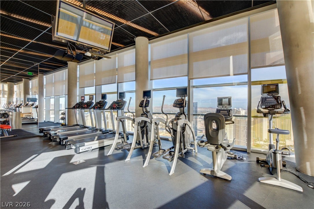 3722 Las Vegas Boulevard, #303, Las Vegas, NV 89158 Floor-to-ceiling windows flood the modern workout space with natural light and dramatic city views.