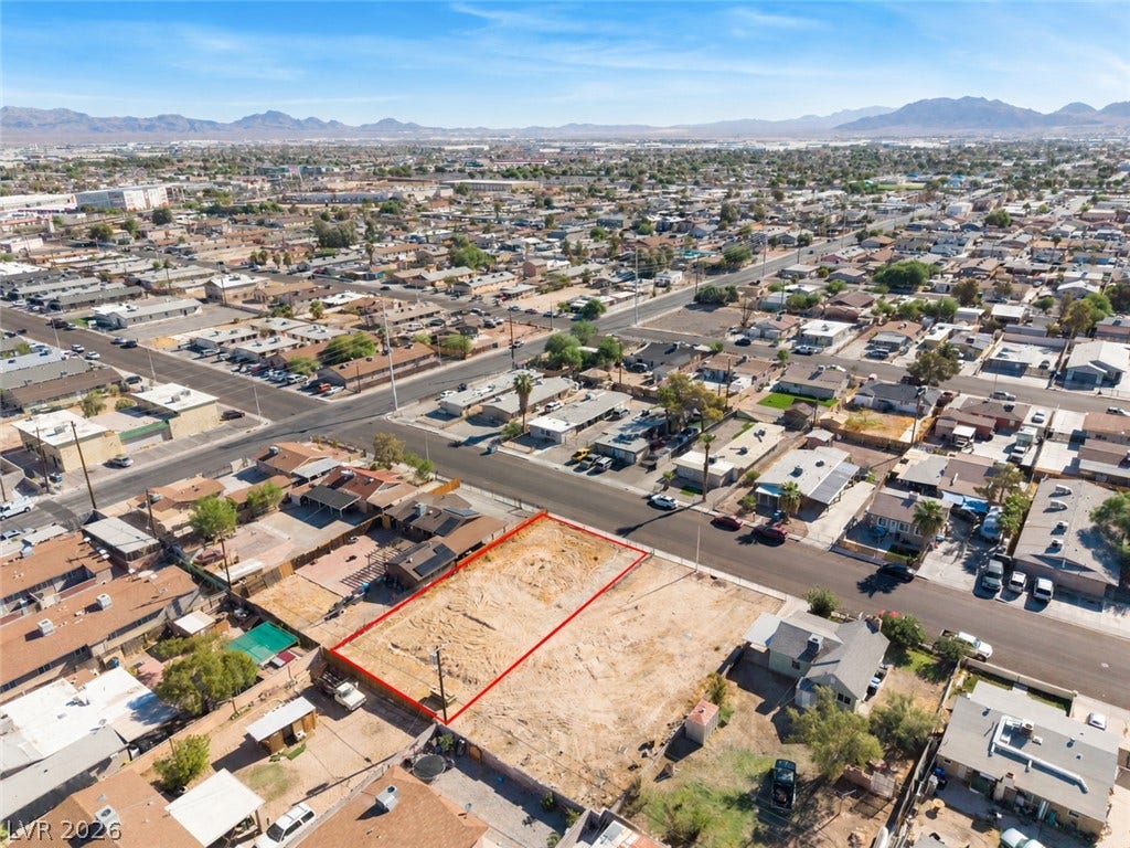 2321 McCarran Street, North Las Vegas, NV 89030 An expansive vacant lot sits nestled within an established suburban neighborhood with majestic mountain backdrops.