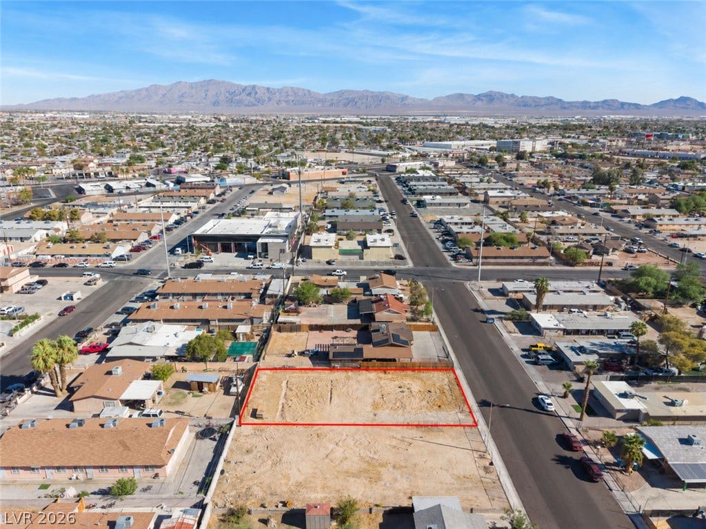 2321 McCarran Street, North Las Vegas, NV 89030 A vacant lot sits ready for development near surrounding residential neighborhoods and distant mountains.